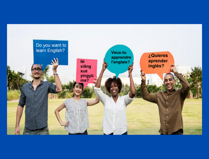 Four adults with signs in different languages that all say: Do you want to Learn English? 